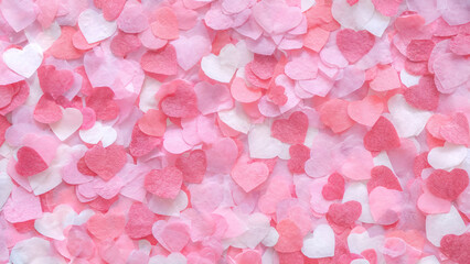 Fototapeta premium Valentine's Day, A vibrant and heartfelt assortment of pink and white heart-shaped confetti scattered across a surface