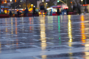 Wet Pavement at Dusk Capturing the Beautiful City Lights Reflection