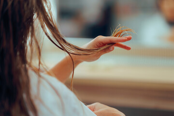 Woman with Wet Hair Looking for Damage and Slip Ends. Girl needing hair treatment anti breakage and dishevelment 
