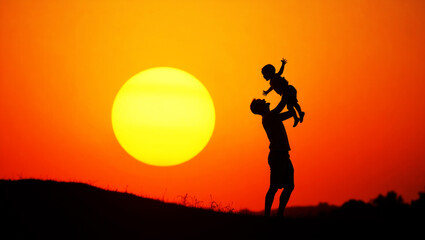Sunset silhouette of father and son playing together.