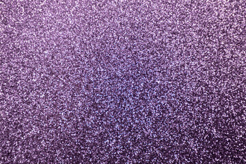 Full frame macro abstract texture background of a sparkling lavender pink color glitter surface
