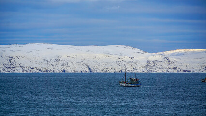 Barents Sea in the Arctic Ocean, where snow-capped mountains meet the vast, icy expanse of the sea. The polar landscape exudes a sense of pristine wilderness, . Ideal for nature and adventure