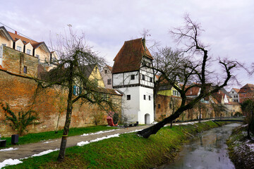 Fototapeta premium White-washed tower that forms part of the medieval walls of a town in Bavaria with the Danube River flowing nearby