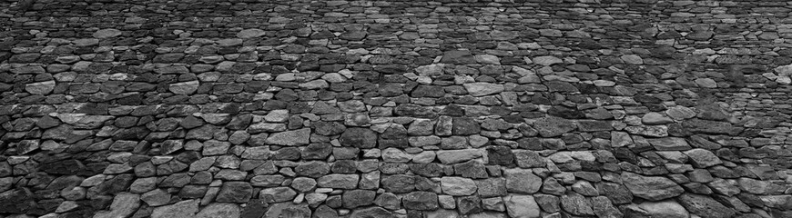 Old historical stone wall background texture close up. Texture pattern of stone fence. aged castle stone wall texture background. Stone wall as a background or texture. Part of stone wall backdrop.