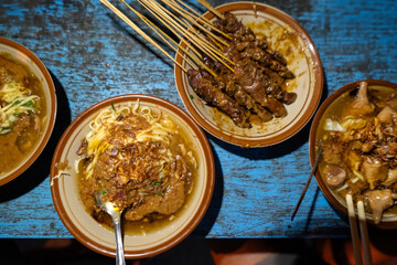 mie ongklok or ongklok noodles served with beef satay, traditional noodles food from Wonosobo, indonesia