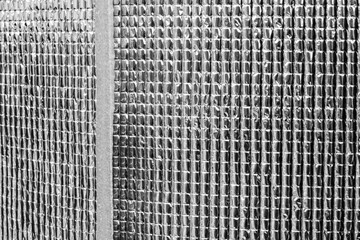 Heat insulating aluminum sheet. Insulates from outside heat and retains coolness. Silver rolls material building materials in a hardware store. close-up, foil film.