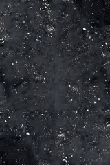 Obraz premium A dark, textured surface with scattered white specks resembling snow or dust. The background is predominantly black with a rough, uneven appearance, creating a moody and abstract effect.