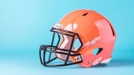 Fototapeta premium Bright Orange Football Helmet Isolated on Vibrant Blue Background