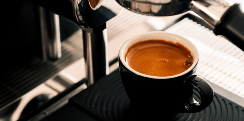 4K Pouring coffee stream from professional machine in cup. Barista man making double espresso, using filter holder. Flowing fresh ground coffee. Drinking roasted black coffee in the morning.	
