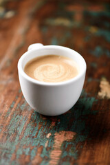 Cup of coffee on wooden background. Soft focus.
