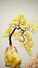 The yellow  Bonsai tree in a vase, closeup of photo