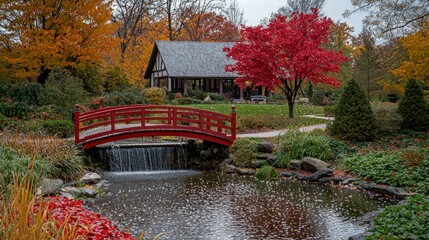 Red bridge over pond with waterfall, autumn park, background house