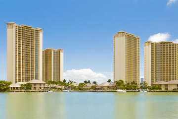 Luxury Waterfront Condominiums Reflect in the Calm Waters of a Tropical Marina