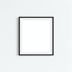 Fototapeta premium A blank white canvas in a black frame against a white wall.