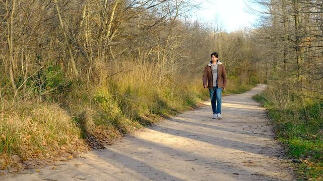 Singly man walking in forest