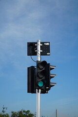 Traffic light with blue clear sky.