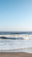 Waves crashing gently on a serene beach during the early morning