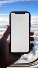 Hand holding cell phone and blue sky,using smartphone with blank screen,A white screen smartphone mockup in a man's hand,social media, mobile application,chatting,copy space.