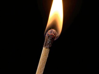 Close up shot of a matchstick burning in vivid detail, safety, ignite