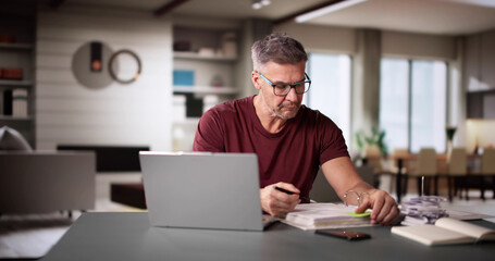 Man Doing Taxes And Family Budget