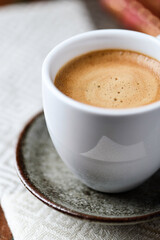 Fototapeta premium Cup of coffee on wooden background. Soft focus. Copy space