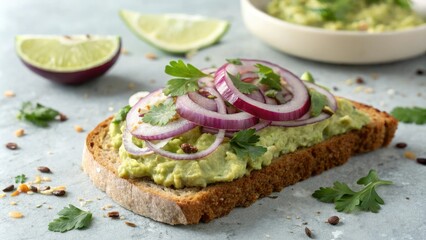 Close-up shot of a slice of toasted whole grain bread topped with creamy avocado spread sliced red onion and chopped fresh cilantro, avocado toast, healthy snack, food texture, whole grain bread