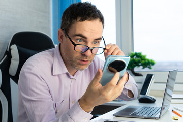 The bald youth looked very surprised when he saw his smartphone screen, advertisements and copy...