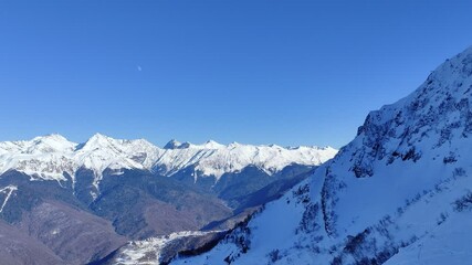 KRASNAYA POLYANA, SOCHI, KRASNODAR KRAI - 09 JANUARY 2025: Mountain landscape and views of the mountain resort infrastructure in winter during peak season.