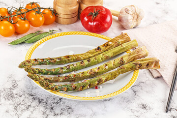Grilled asparagus sprouts served red pepper