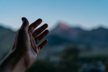 A woman's hand on the background of the snowy peak of Mount Kazbek. The feeling of uniqueness of...