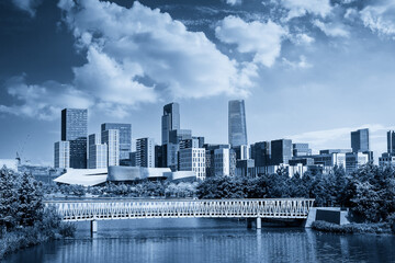 Obraz premium Serene Urban Landscape with Modern Architecture and Scenic Waterway