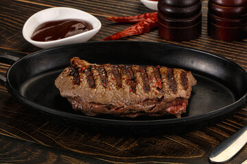 Grilled beef striploin steak with sauce