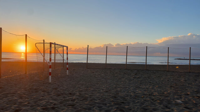 Football pitch in the sand at the beach during sunrise