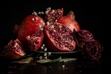 Still life with pomegranates, roses and dried leaves © Cavan