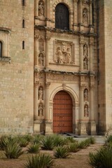 Facade of a Historic Church with a Large Wooden Door in Oaxaca, Mexico
