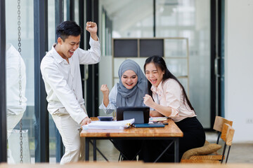 Financial Advisor discussion group of four happy young asian corporate people teammates meeting discussing business in the workplace office.
