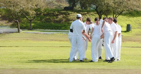 Teams of multiracial male cricket players wearing cricket white on pitch - Powered by Adobe
