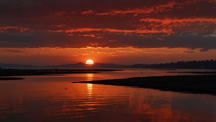 Obraz premium Sunset over the lake . A fiery sunset over a calm body of water . Amazing scene of sunset .