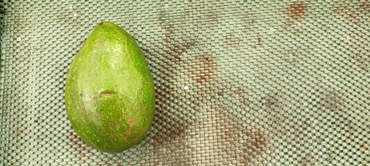 green avocados on supermarket shelves