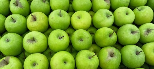 green apples on the fruit shelves of supermarkets
