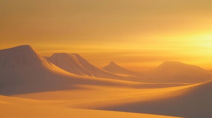 Golden sunset illuminating snow-covered mountains.