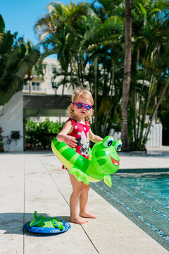 Young girl getting ready to jump in pool