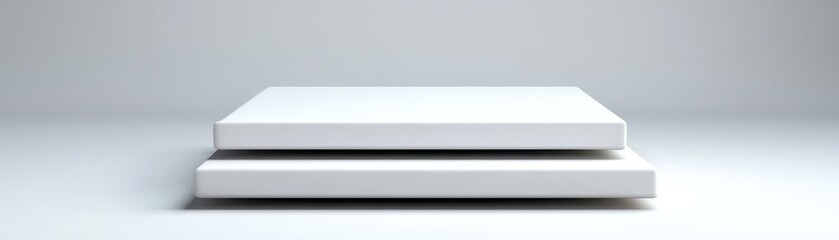 Obraz premium Minimalist stacked books on a clean surface, perfect for modern design aesthetics.