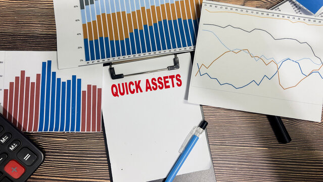 Concept of Quick Assets write on paperwork isolated on Wooden Table.