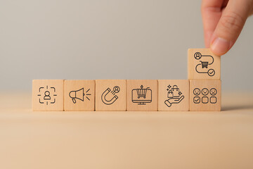 Customer Journey Concept. Wooden blocks with customer journey icons representing e-commerce,...