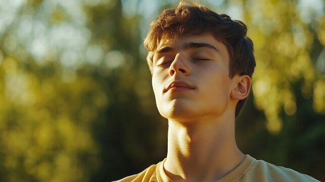 Calm boy enjoying fresh air, meditation with breathing