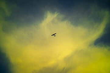 Low angle view of airplane flying against blue sky backgrounds at dusk