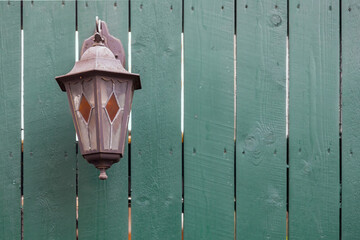 old street lamp on wooden wall. front view on facade with copy space