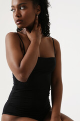 Naklejka premium Portrait of young lovely woman with dark skin isolated over white background looking away.