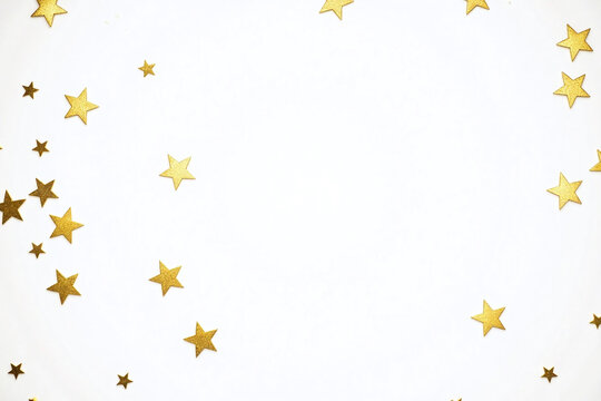 scattered gold star confetti against plain white background randomly